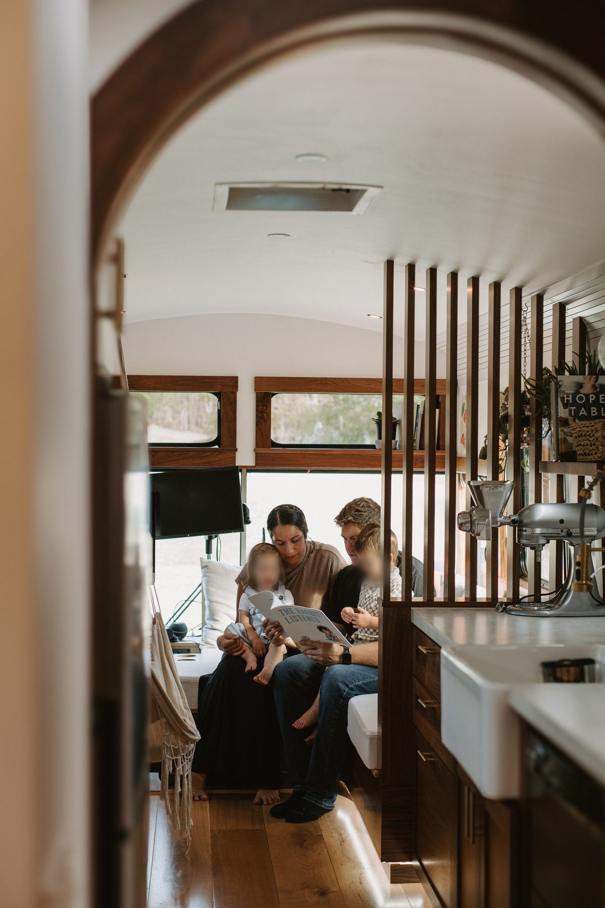 Looking down the length of the bus through the arched walnut doorway