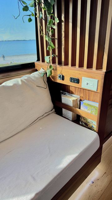 The couch nook and the walnut-and-maple slat wall