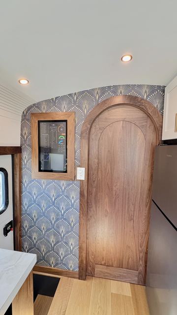 Arched walnut pocket door and the art deco paper