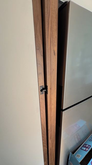 Pocket door alongside the fridge