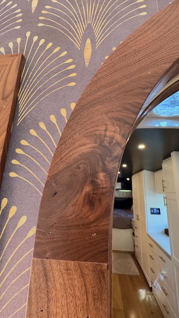 Walnut arch against the wallpaper