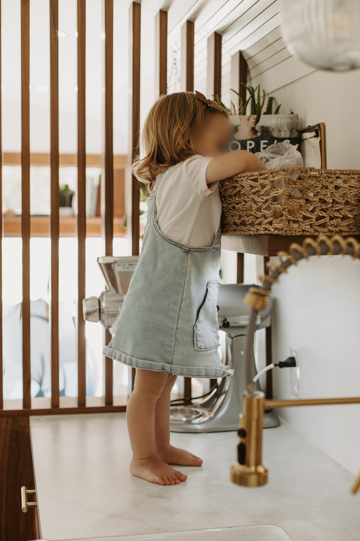 Kitchen counter with farmhouse sink and slat wall